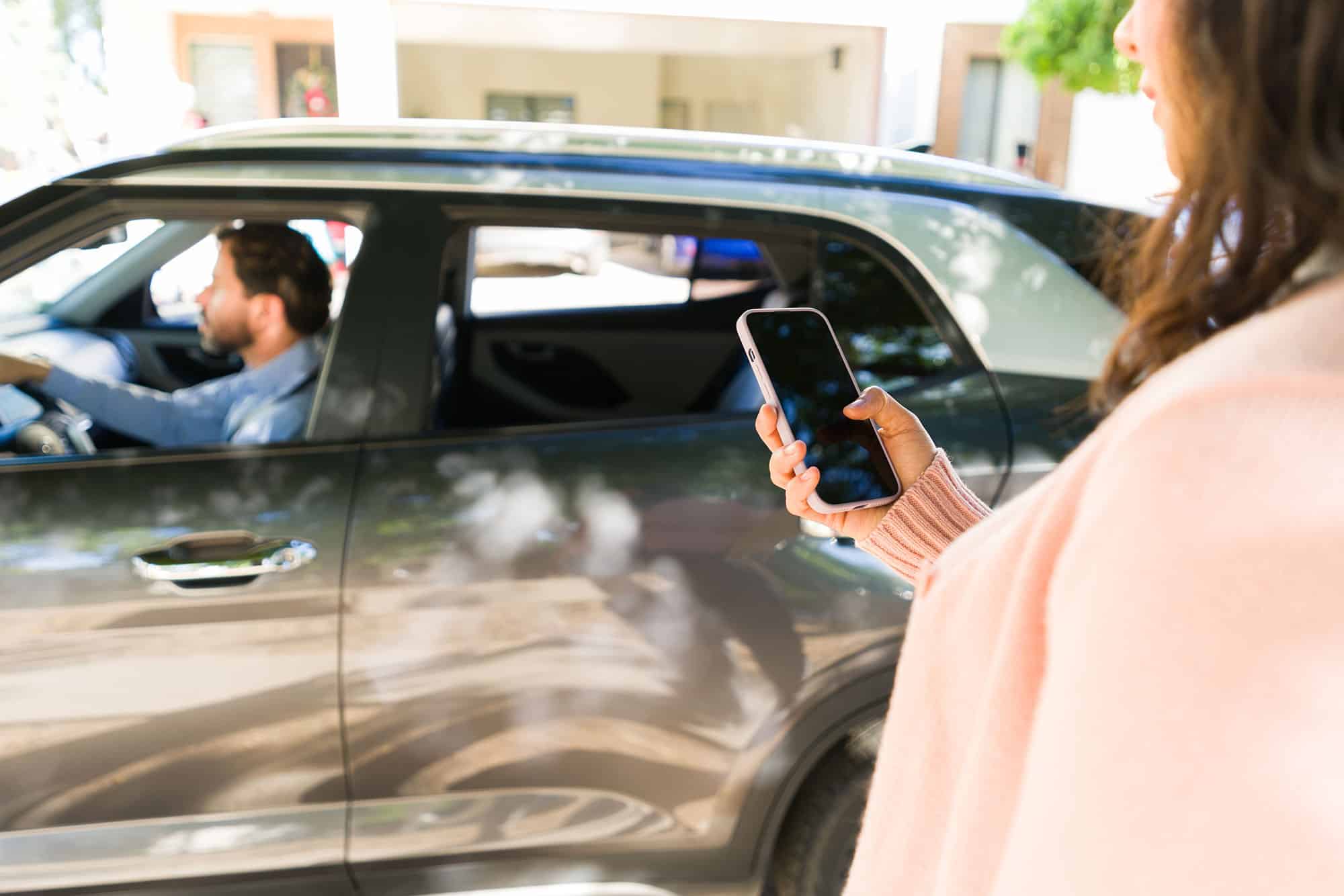 woman on phone after calling rideshare service