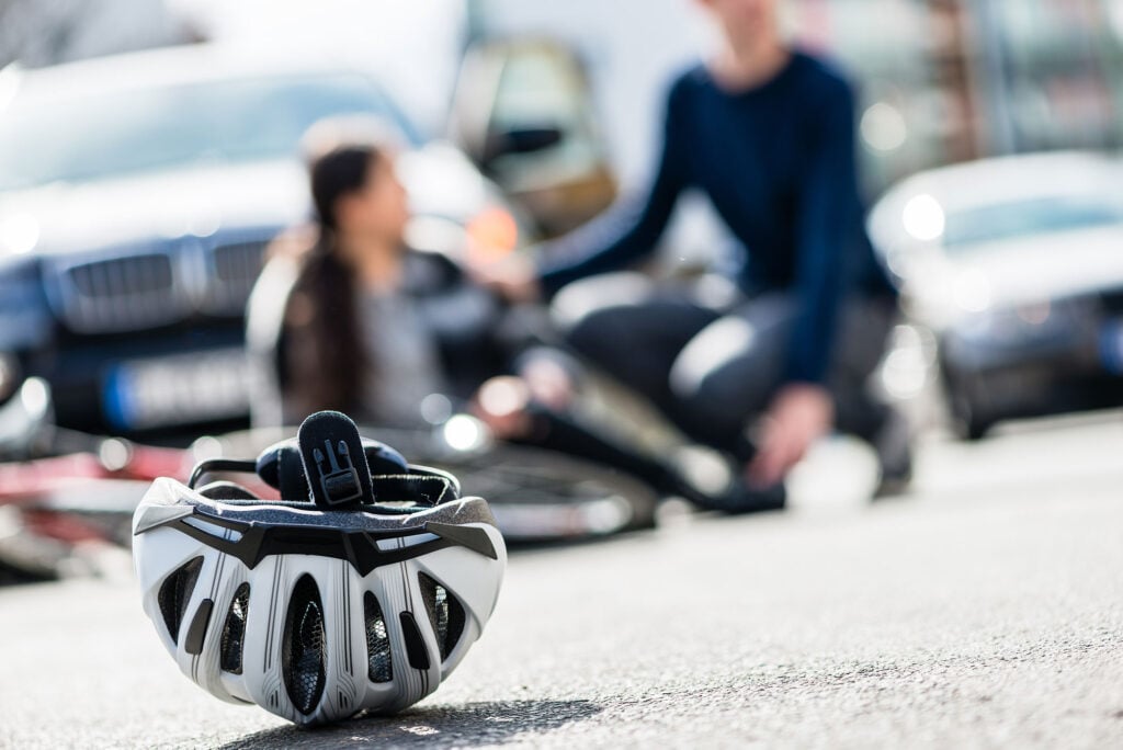 bicycle accident with helmet in foreground